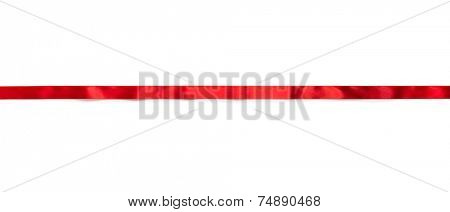 Extending simple red ribbon with typical ripples or wrinkles of a silky or satin ribbon , isolated on white. 