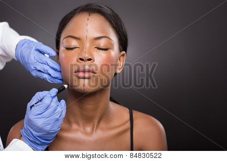 doctor draw correction line on a patient before cosmetic surgery 