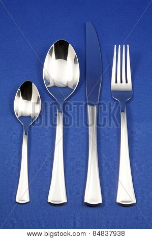 Silver cutlery on blue background