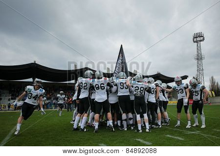 VIENNA, AUSTRIA - MARCH 23, 2014: The team of the Swarco Raiders huddles up before an AFL football game.