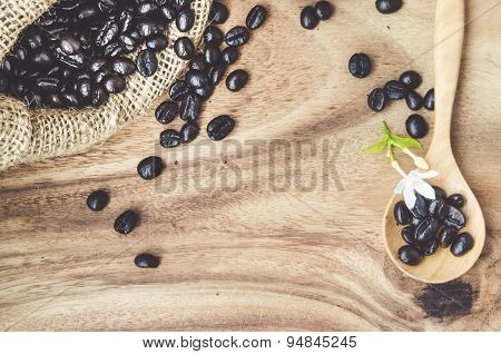 Studio Shot Of Coffee Beans In A Bag With Wooden Table: Vintage Process