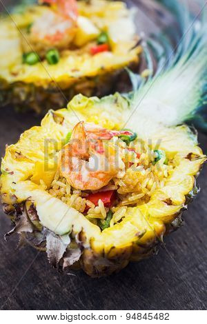 Pineapple fried rice shrimp on wooden table