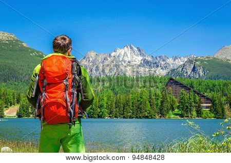 Young man with orange backpack at Strbske Pleso