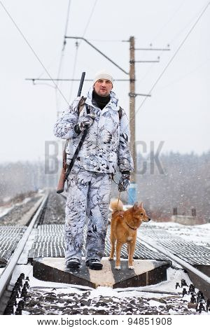 The Hunter With His Dog On The Railroad Crossing