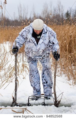 Hunter Setting A Trap For Beaver