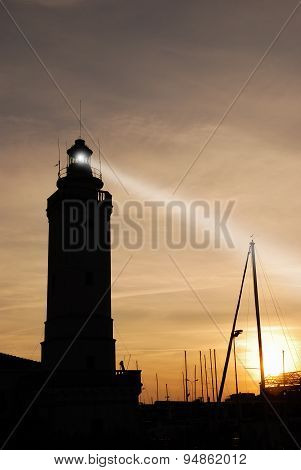 Lighthouse At Sunset On The Port