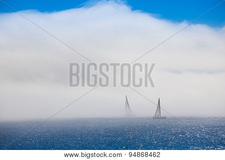 Lonely Sailboats In The Morning Mist