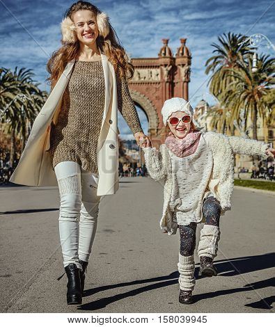 Mother And Daughter Near Arc De Triomf In Barcelona Walking