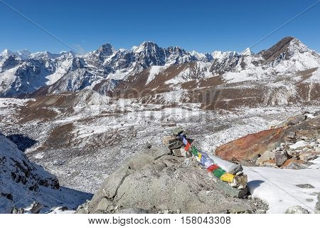 Buddhist Prayer Flags On Mountain Cairns On Everest Base Camp Route In Himalayas, Nepal. Waving Budd