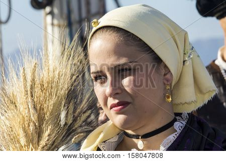 CAGLIARI, ITALY - October 29, 2016: Invitas waterfront Porto Sardinia performances of traditions and food. - Portrait of a beautiful girl in the folk group Is massaius de Santu Isidoru - Teulada