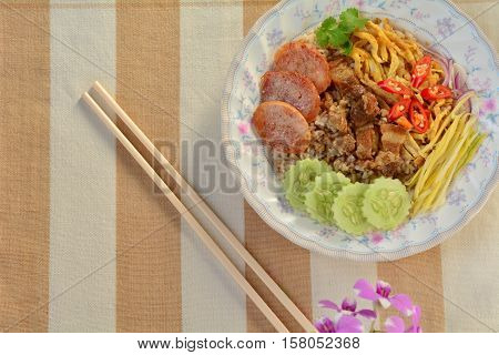 Rice mixed with shrimp paste with chopstick.