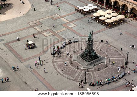Krakow Poland - June 07 2011: Top view of the Main Square with monument to Adam Mickiewicz. Krakow has been awarded a number of top international rankings such as the 1st place in the Top city-break destinations.