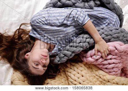 Girl with large knit blanket s giant knit blanket super chunky yarn arm knitting