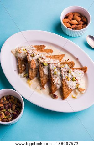 Shahi Tukda prepared - deep fried bread in ghee, garnish with sweetened cream and dry fruits.