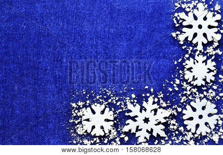 Christmas decoration.Snowflakes border on blue background with copyspace.Christmas snowflakes.Christmas border.Snowflakes background.Winter holidays,Christmas,Happy New Year concept.Selective focus