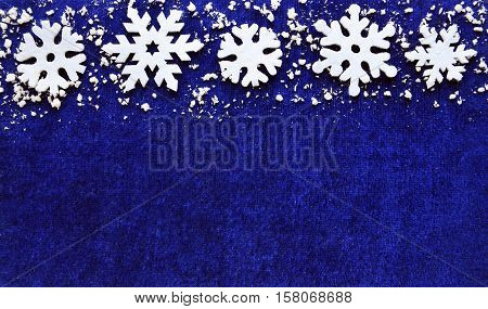Christmas decoration.Snowflakes border on blue background with copyspace.Christmas snowflakes.Snowflakes background.Winter holidays,Christmas or Happy New Year concept.