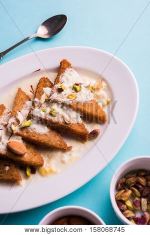 Shahi Tukda prepared - deep fried bread in ghee, garnish with sweetened cream and dry fruits.