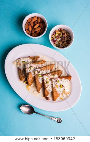 Shahi Tukda prepared - deep fried bread in ghee, garnish with sweetened cream and dry fruits.
