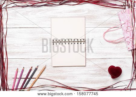 Frame for valentine's day, Birthday, Mother's Day. Top view with copy space. Photos for posts, blogs, advertising and news. White wooden background with frame. Greeting concept card