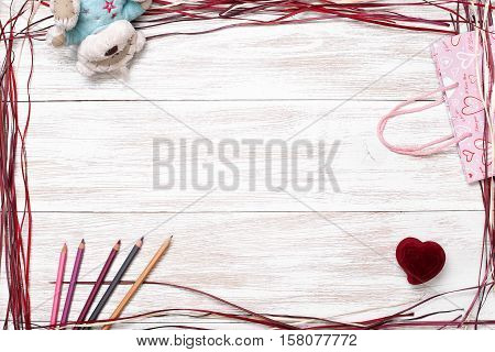 Frame for valentine's day, Birthday, Mother's Day. Top view with copy space. Photos for posts, blogs, advertising and news. White wooden background with frame. Greeting concept card
