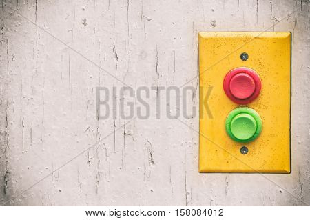 Yellow panel with red and green buttons over bright background