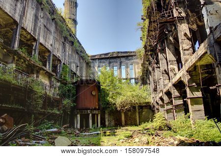 Abandoned, destroyed by war and overgrown machinery of Tkvarcheli power plant, Abkhazia, Georgia