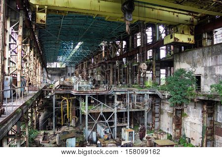 Abandoned, destroyed by war and owergrown machinery of Tkvarcheli power plant, Abkhazia, Georgia