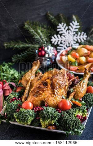 Whole roasted chicken and vegetables, Christmas concept