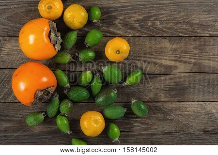 Mixed exotic fruits on wooden background. Close up
