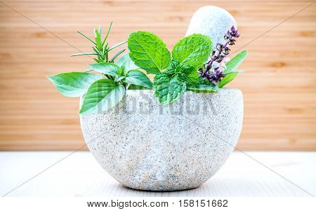 Alternative Health Care And Herbal Medicine .fresh Herbs With Mortar And Pestle On Wooden Background