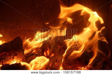Red-hot coals with blue flame in an oven