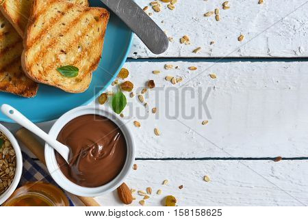 Good morning - toast with Nutella banana and honey. White food background.