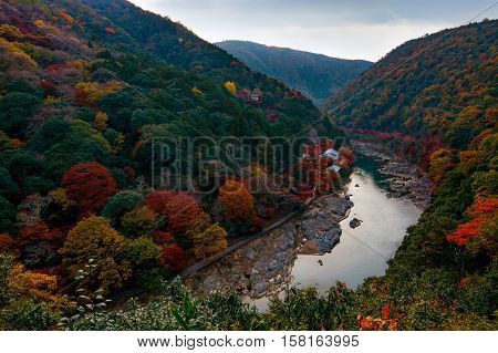 Autumn colors along the Katsura River in the Arashiyama area of Kyoto, Japan just after sunset