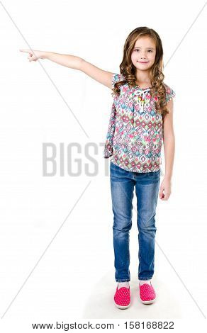 Cute little girl is pointing to the side isolated on a white