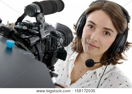 beautiful young woman with DSLR video camera and headphones