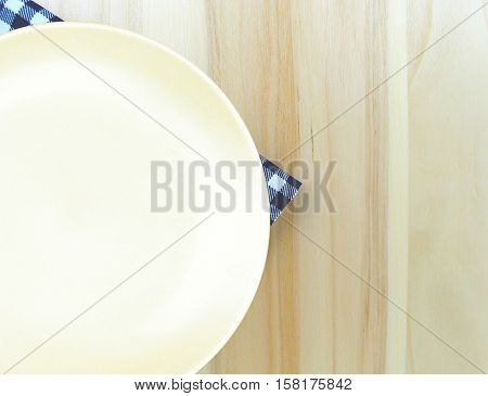 Top view plate on checkered tablecloth pattern background .Free space for products and for your text