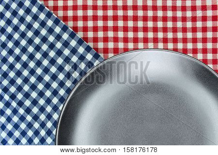 Top view plate on checkered tablecloth pattern background .Free space for products and for your text