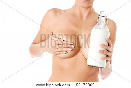 Nude woman is holding a ewer of milk. Spa concept.