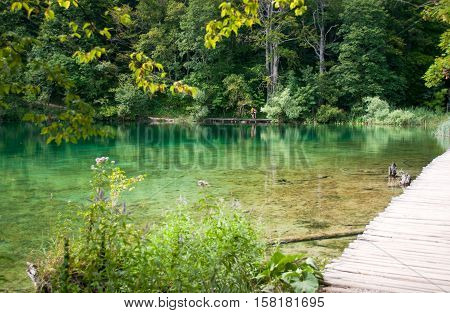 Tourists walking along a hiking path across the lake