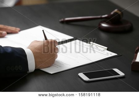 Man signing power of attorney, closeup