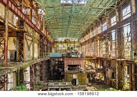 Abandoned, destroyed by war and overgrown machinery of Tkvarcheli power plant, Abkhazia, Georgia