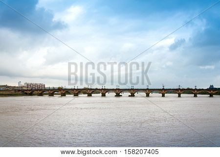 Old stony bridge in Bordeaux, France Europe