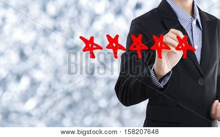 Business hand check mark with red marker on five star rating. concept customer service excellent.