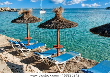 Beautiful seascape with yacht and sun umbrellas. Spain Majorca
