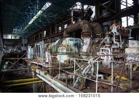Abandoned, destroyed by war and overgrown machinery of Tkvarcheli power plant, Abkhazia, Georgia