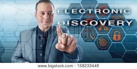 Smiling male governmental investigator pushing ELECTRONIC DISCOVERY on an interactive touch screen. Information technology concept touching on litigation digital evidence email and civil procedure.