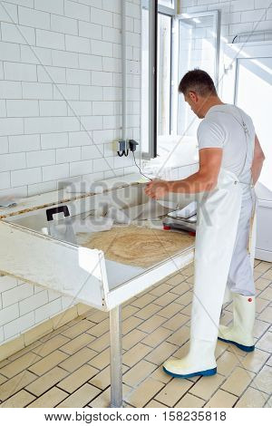Cheesemaker Weighs Gruyere De Comte Cheese At The Dairy