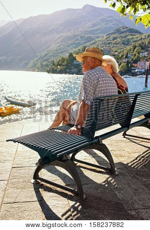 Couple Sitting On Bench Of Ascona Resort At Ticino Switzerland