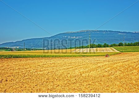 Tractor at field works in a Swiss village Yverdon les Bains in Jura Nord Vaudois district of Canton Vaud Switzerland.