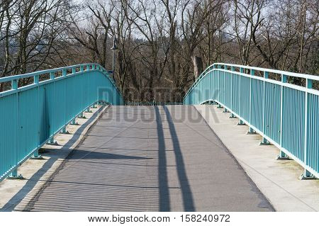 Pedestrian bridge steel arch structure over the river Ruhr in Muelheim Germany.